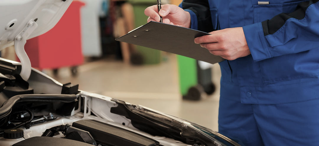 man examining car