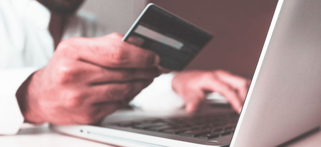 person shopping online using his laptop